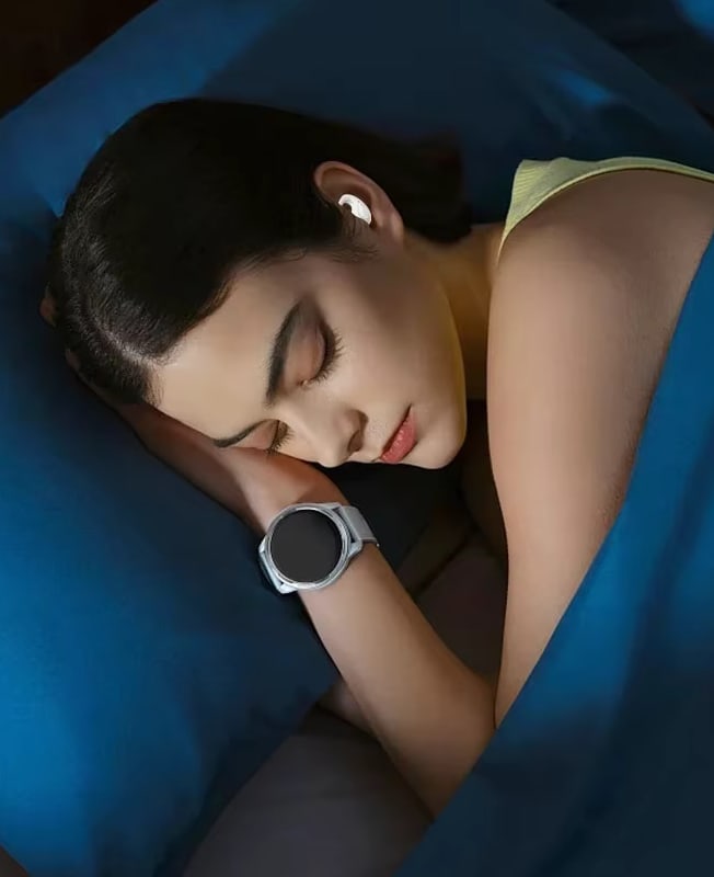 A woman asleep on her side with a Sleep Earbud in her ear